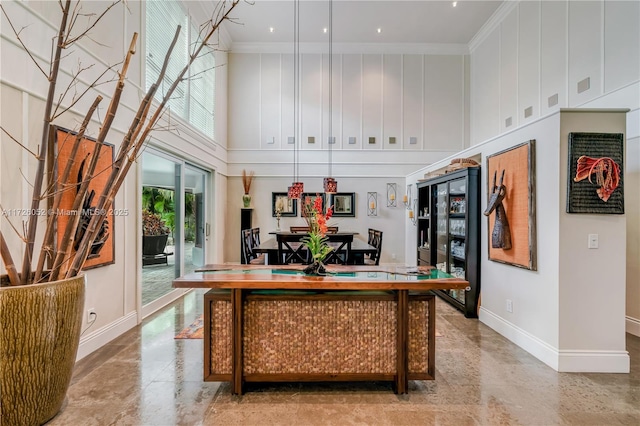 interior space with a high ceiling and ornamental molding