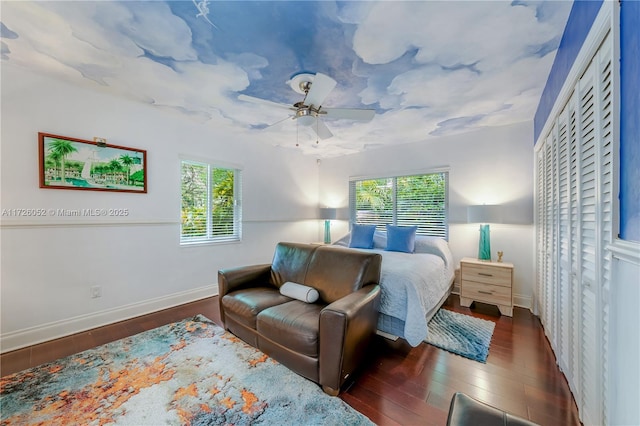 bedroom featuring ceiling fan, dark hardwood / wood-style flooring, and a closet