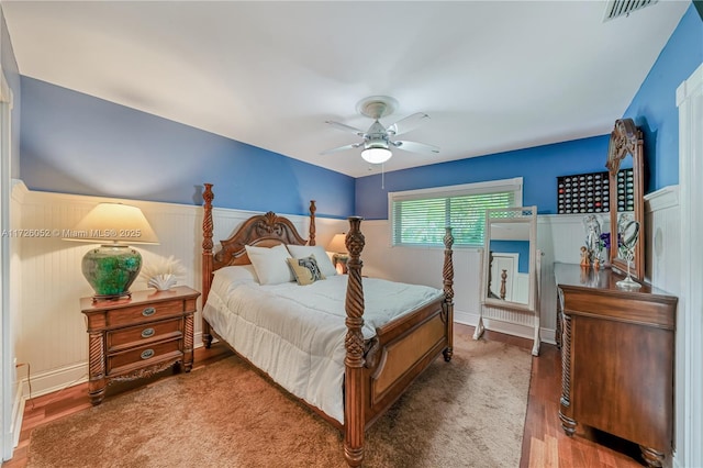 bedroom with ceiling fan and hardwood / wood-style flooring