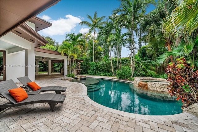 view of pool featuring a patio and an in ground hot tub