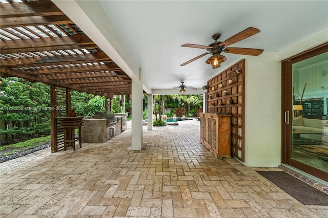 view of patio / terrace with exterior bar, a pergola, an outdoor kitchen, a grill, and ceiling fan