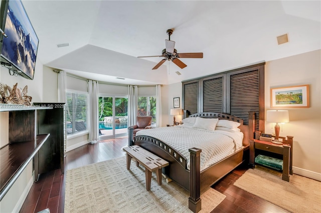 bedroom with access to outside, ceiling fan, vaulted ceiling, and dark hardwood / wood-style floors