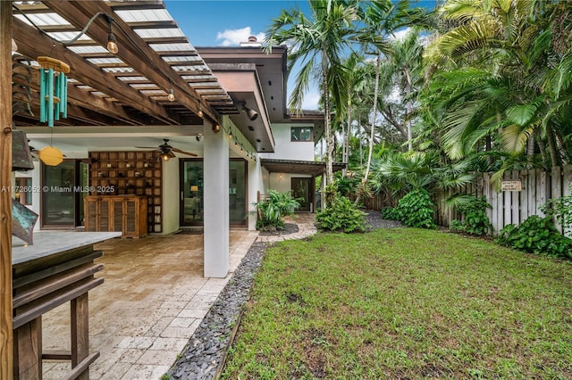 view of yard with a patio and ceiling fan