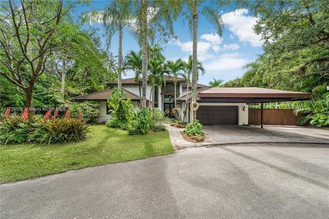 view of front of property with a front lawn and a garage