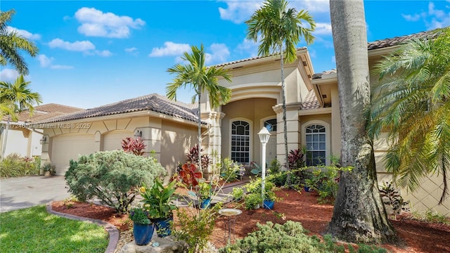 mediterranean / spanish home with a garage