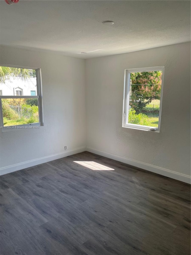 unfurnished room featuring dark hardwood / wood-style flooring