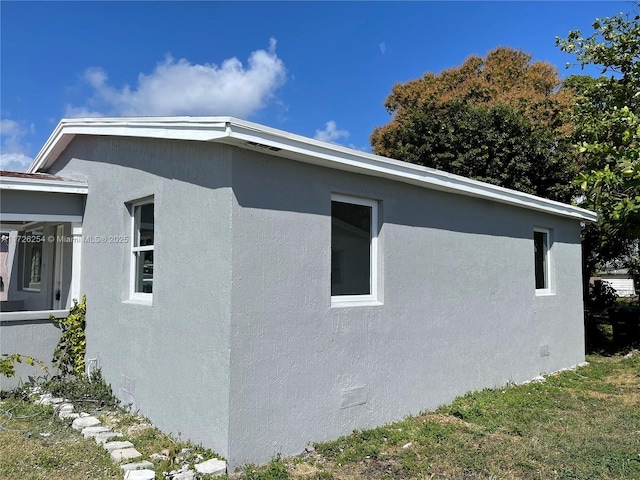 view of side of home with a lawn