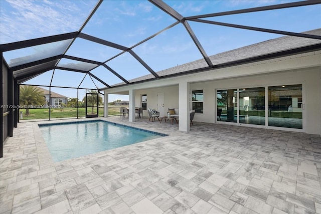 view of pool featuring glass enclosure and a patio area