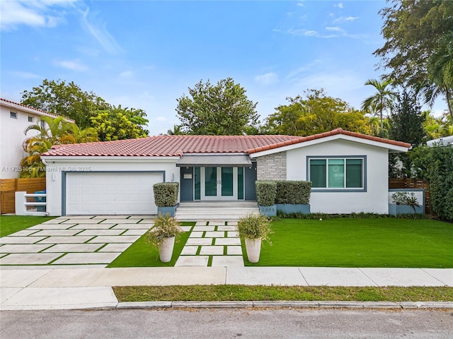 view of front of property featuring a garage and a front lawn