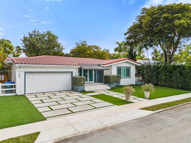 view of front of property featuring a front yard and a garage