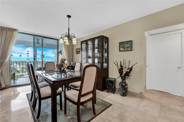 dining area featuring floor to ceiling windows and an inviting chandelier