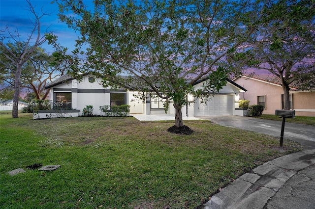 view of front of property featuring a yard and a garage