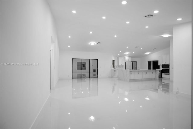 unfurnished living room with lofted ceiling