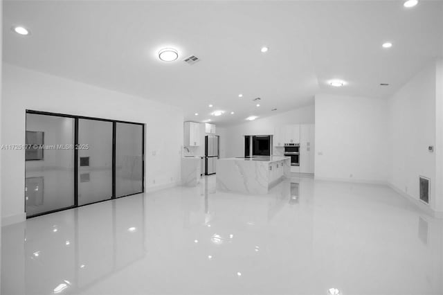 living room with sink and vaulted ceiling