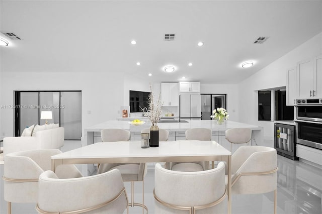 tiled dining space with lofted ceiling