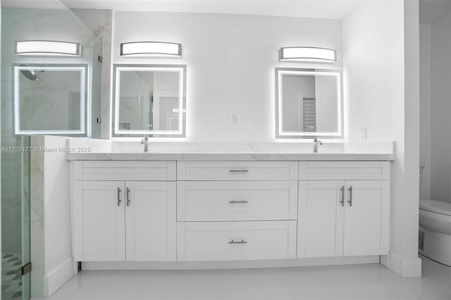 bathroom with an enclosed shower, vanity, and toilet