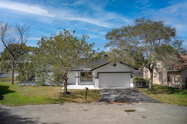 view of front facade with a front yard and a garage