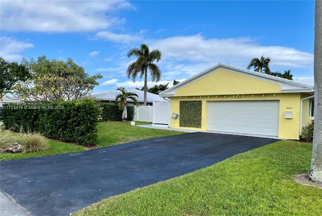 view of front of property featuring a front lawn and a garage