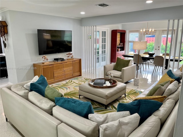 living room with a notable chandelier and french doors