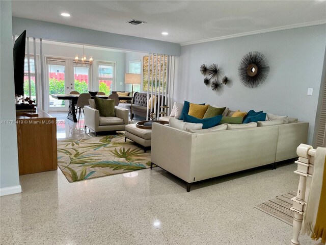 living room featuring ornamental molding and a notable chandelier