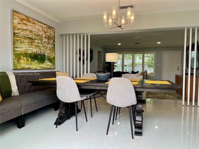 dining space with ornamental molding and an inviting chandelier