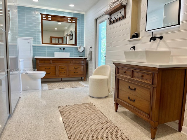 bathroom featuring vanity, tile walls, and crown molding