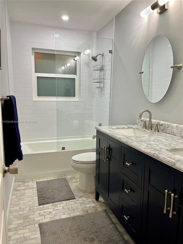 full bathroom with toilet, vanity, and tiled shower / bath combo