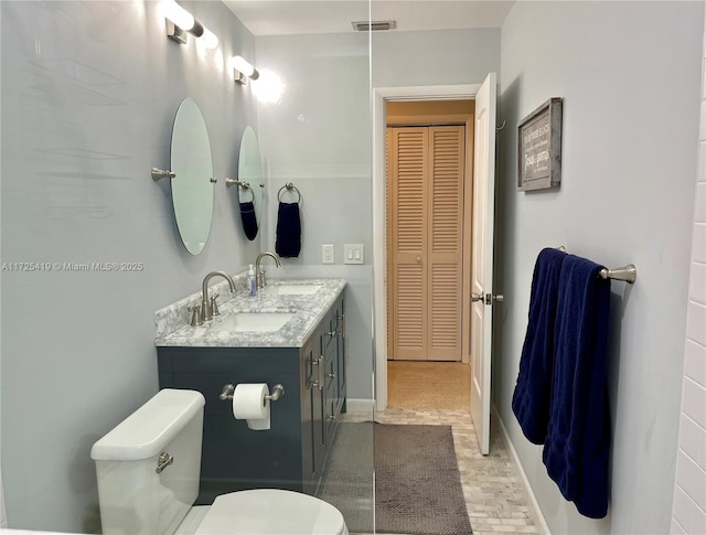 bathroom featuring toilet and vanity