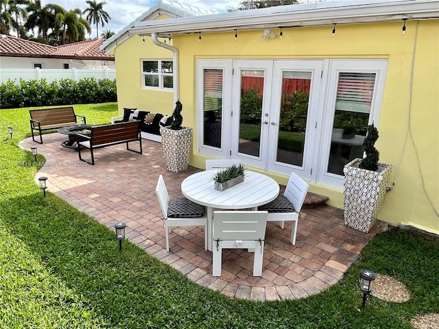 view of patio / terrace with an outdoor living space with a fire pit and french doors