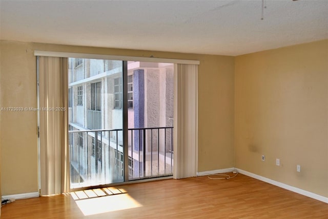 unfurnished room with light wood-type flooring