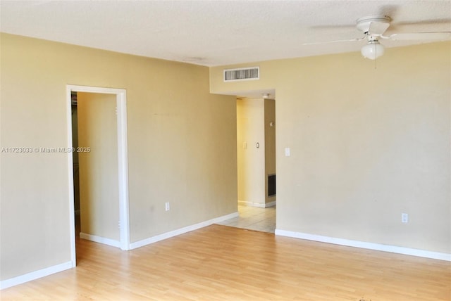 unfurnished room with ceiling fan and light hardwood / wood-style flooring