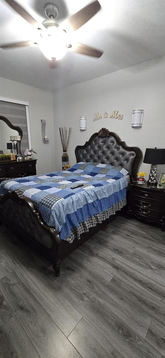 bedroom with ceiling fan and dark hardwood / wood-style flooring