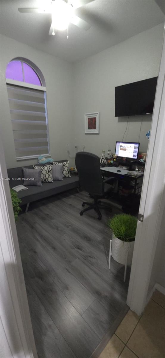 office with ceiling fan and tile patterned floors