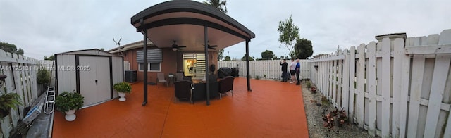 view of patio / terrace featuring ceiling fan and a storage shed