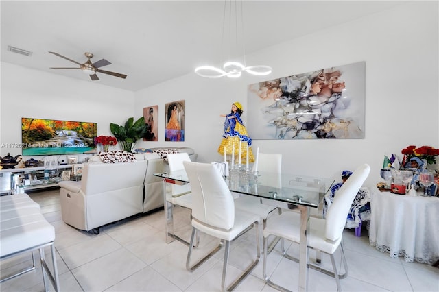 dining room with light tile patterned floors, visible vents, and ceiling fan