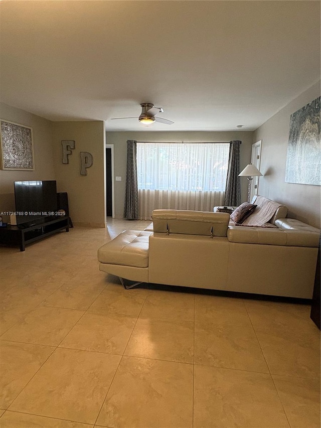 unfurnished living room with light tile patterned flooring and ceiling fan