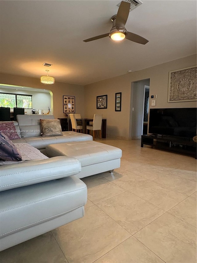 living room with ceiling fan and light tile patterned floors