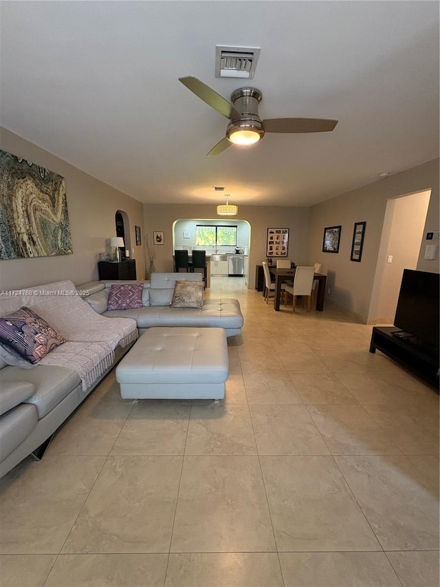 tiled living room with ceiling fan