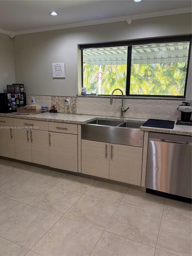 kitchen featuring sink, stainless steel dishwasher, decorative backsplash, light stone countertops, and crown molding