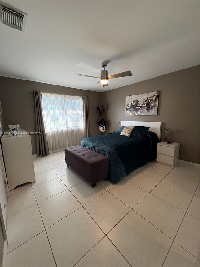 tiled bedroom with ceiling fan