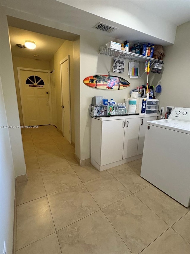 washroom with washer / dryer and light tile patterned floors