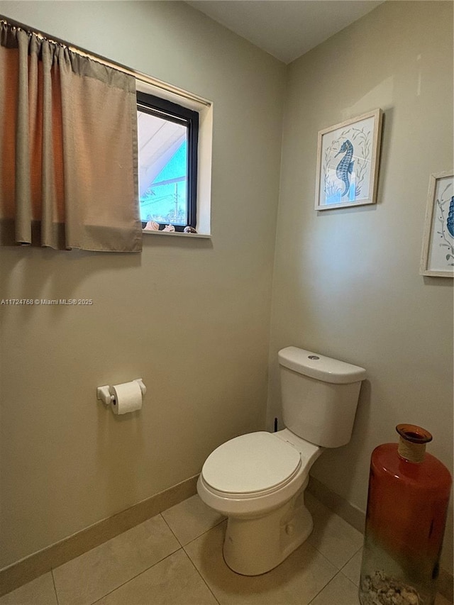 bathroom with tile patterned floors and toilet