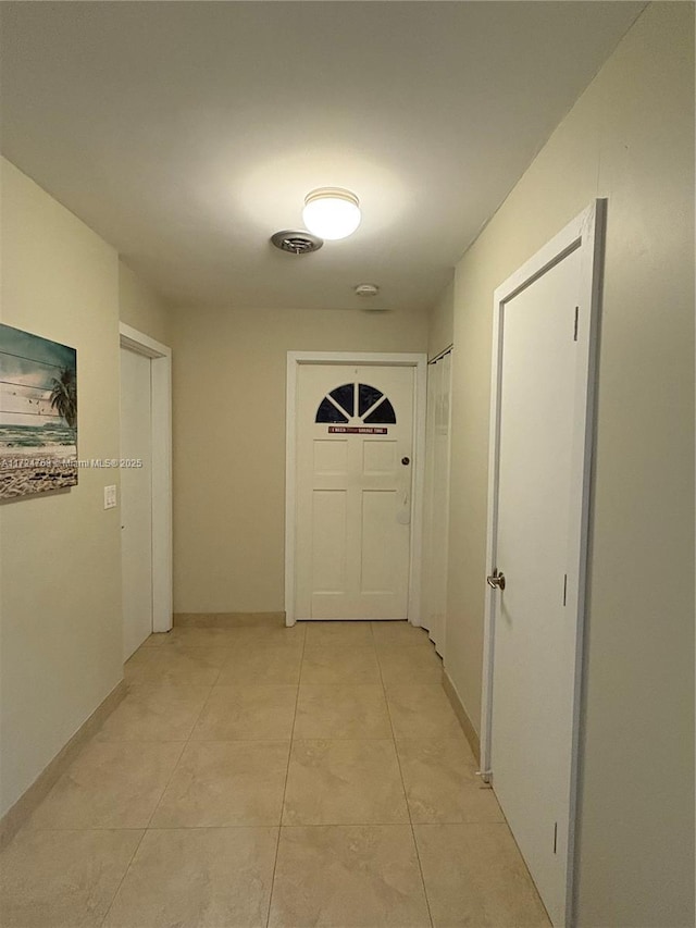 corridor featuring light tile patterned flooring