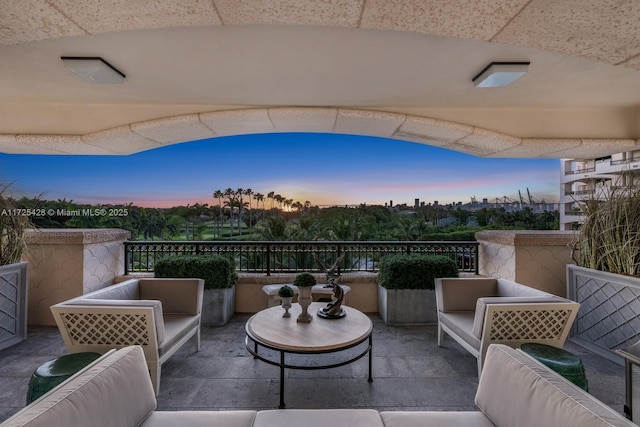 balcony at dusk featuring outdoor lounge area