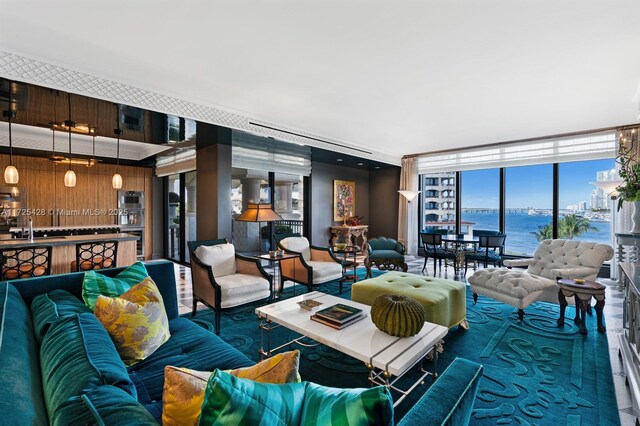 living room with a water view and a wall of windows