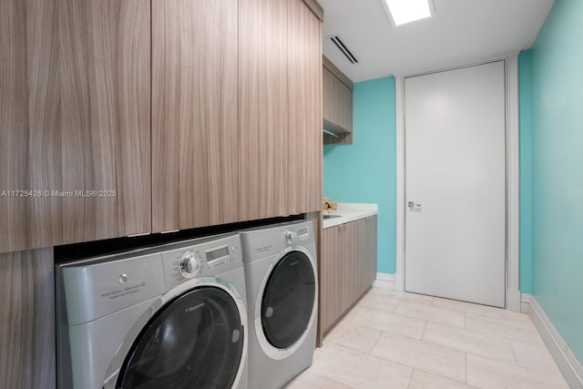 clothes washing area with separate washer and dryer, baseboards, laundry area, and visible vents