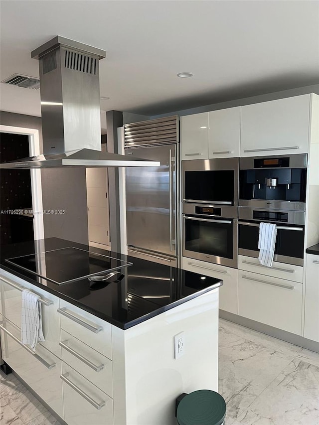 kitchen featuring stainless steel appliances, white cabinetry, and island range hood