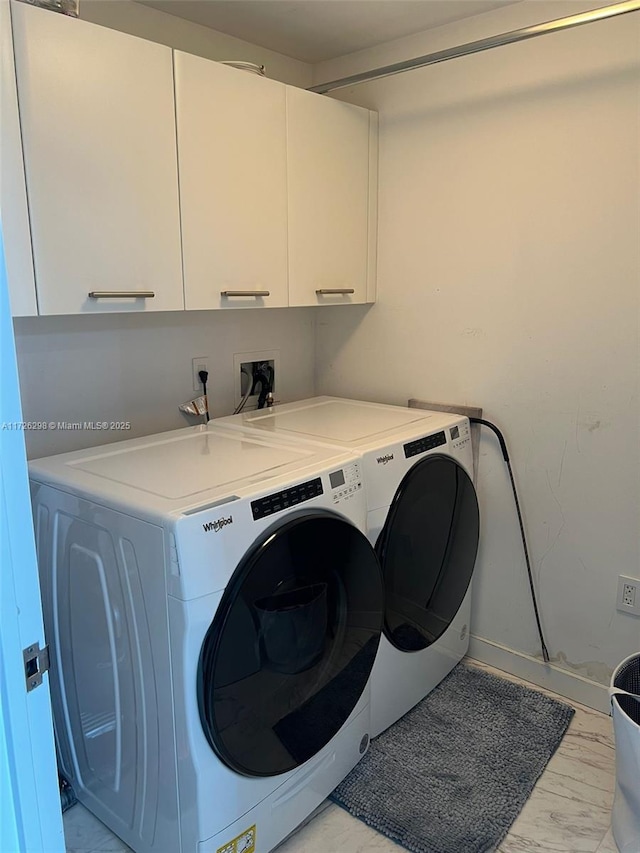 laundry room featuring cabinets and independent washer and dryer