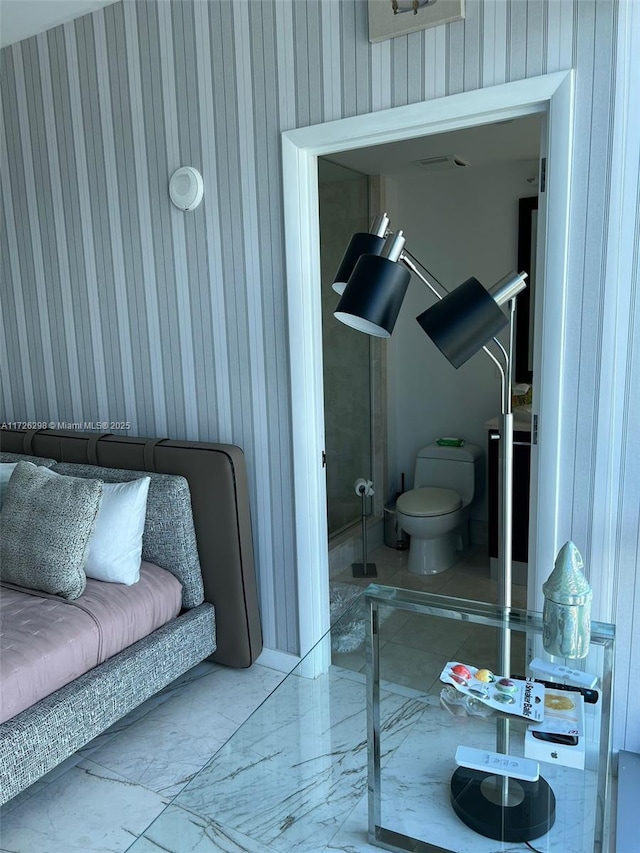 bathroom with wood walls and toilet