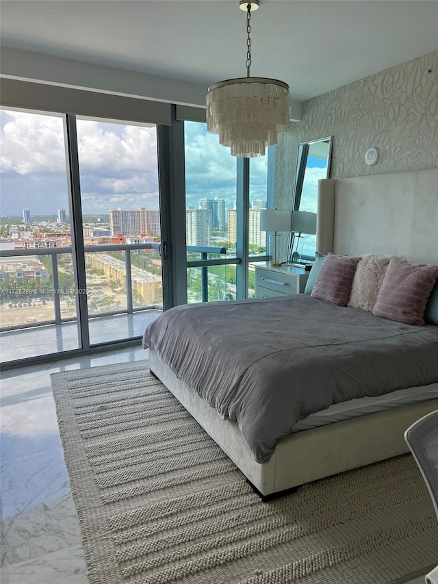 bedroom featuring a notable chandelier and access to exterior